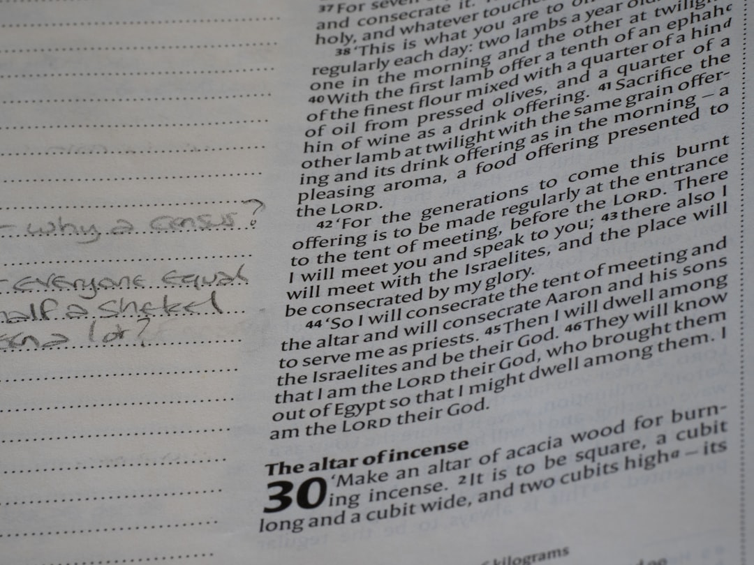 Close-up of text in a book with handwritten notes.