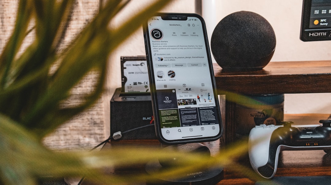 a cell phone sitting on top of a table next to a plant