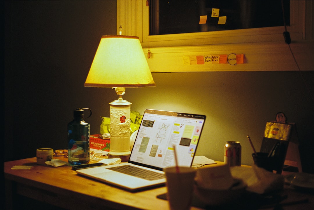 a laptop computer sitting on top of a wooden desk