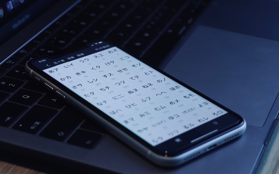 black android smartphone on laptop computer