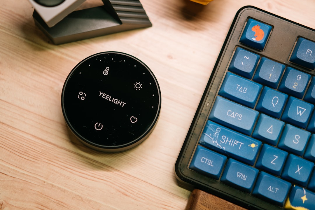 A yeelight controller sits near a colorful keyboard.