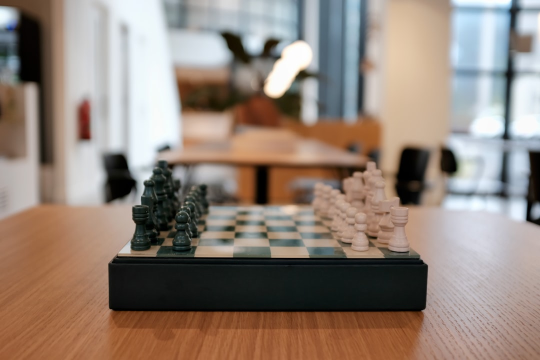 black and white chess piece on brown wooden table