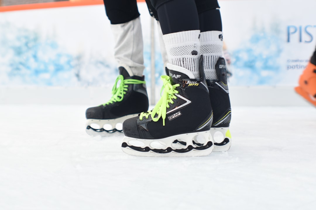 a close up of a person's shoes on a ice rink