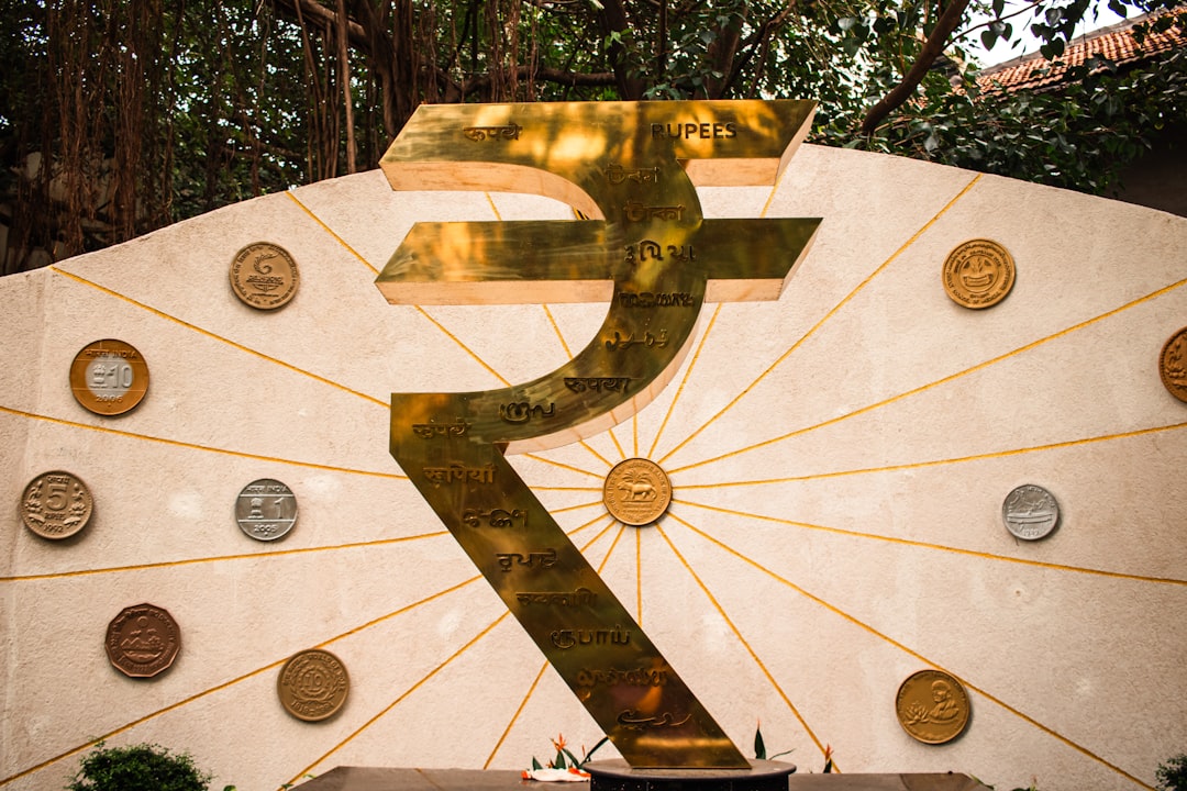 The image features a large indian rupee symbol.