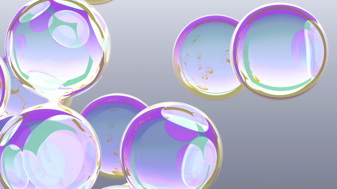 Iridescent bubbles floating against a gray background