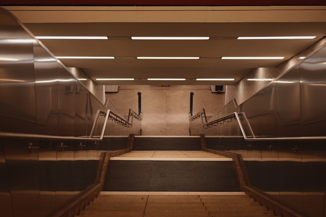A modern subway station staircase with bright lights.